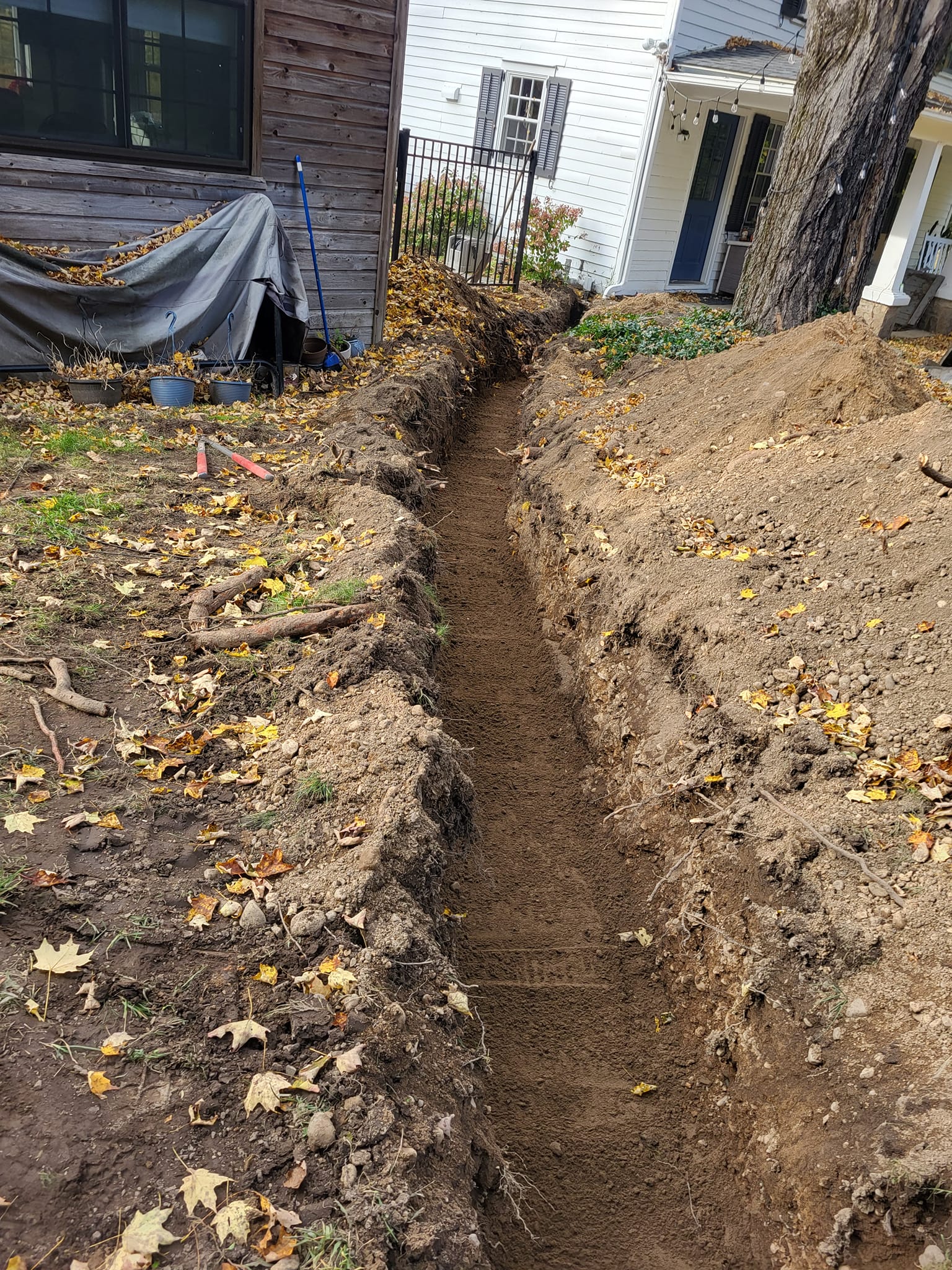 image of an excavated trench on a backyard