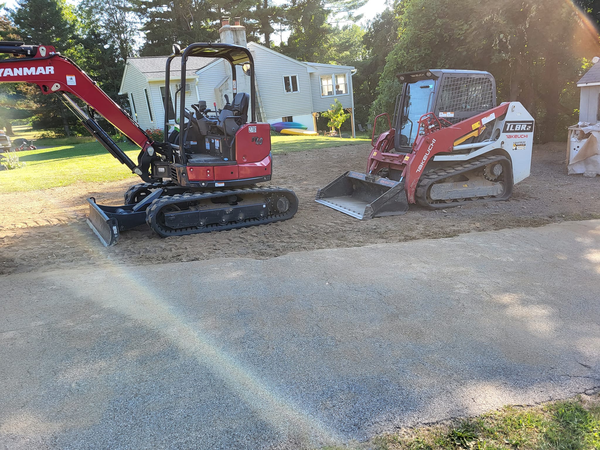 a backhoe and bulldozer parked aligned